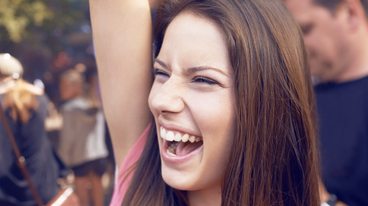 A smiling guest at an outdoor event